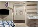 Bedroom view showcases a TV and floating shelves, leading to an arched hallway at 2335 E Allen St, Phoenix, AZ 85042