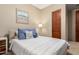 Relaxing bedroom with comfortable bed, coastal decor, and natural light for a peaceful retreat at 2335 E Allen St, Phoenix, AZ 85042
