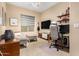Relaxing bedroom with comfortable sofa seating, ambient lighting, and an adjacent work space at 2335 E Allen St, Phoenix, AZ 85042
