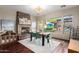 Dining room with fireplace, modern chandelier, and a large window with a view to the backyard at 2335 E Allen St, Phoenix, AZ 85042