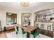 Dining room featuring a modern chandelier, with a large wooden table and backyard view at 2335 E Allen St, Phoenix, AZ 85042