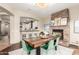 Dining area featuring a stone fireplace, modern chandelier, and adjacent kitchen counter seating at 2335 E Allen St, Phoenix, AZ 85042