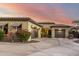 Single-story home featuring a circular driveway, two-car garage, desert landscaping, and a lovely exterior at 2335 E Allen St, Phoenix, AZ 85042