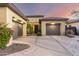 A single-story home featuring desert landscaping, a circular driveway, and a two-car garage at 2335 E Allen St, Phoenix, AZ 85042