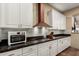 Updated kitchen featuring white cabinetry, stainless steel appliances, and dark countertops at 2335 E Allen St, Phoenix, AZ 85042