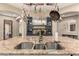 Spacious kitchen island with granite countertop and stainless steel sink provides a perfect space for cooking at 2335 E Allen St, Phoenix, AZ 85042