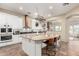 Open kitchen with an island, white cabinetry, modern appliances, and views to the dining area at 2335 E Allen St, Phoenix, AZ 85042