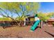 Community playground featuring a slide, swings, and climbing structure with a bench nearby at 2335 E Allen St, Phoenix, AZ 85042