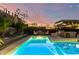 Stunning backyard pool and landscaped patio with string lights, and outdoor seating offer a relaxing outdoor space at 2335 E Allen St, Phoenix, AZ 85042