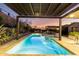 Inviting backyard oasis with pool, spa, outdoor kitchen, and pergola with string lights at 2335 E Allen St, Phoenix, AZ 85042