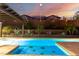 Backyard swimming pool features turtle mosaics and outdoor seating, creating a private oasis with lush landscaping and ambiance at 2335 E Allen St, Phoenix, AZ 85042