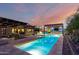Expansive backyard with a refreshing pool, covered patios, barbecue area, and cozy seating at 2335 E Allen St, Phoenix, AZ 85042