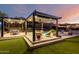 Outdoor space with a covered pergola, pool, lounge area, and lush landscaping at 2335 E Allen St, Phoenix, AZ 85042