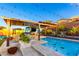 Stunning backyard pool with outdoor seating, colorful mural, and desert landscaping offer a vibrant outdoor experience at 2335 E Allen St, Phoenix, AZ 85042