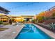A backyard pool with integrated patio, mural, and pergola shading a dining area with beautiful desert landscaping at 2335 E Allen St, Phoenix, AZ 85042