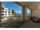 Apartment balcony with seating overlooking manicured landscaping and the building's facade at 2511 W Queen Creek Rd # 266, Chandler, AZ 85248