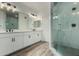 Bathroom featuring a double vanity with an adjacent glass-enclosed shower with marble tile at 2511 W Queen Creek Rd # 266, Chandler, AZ 85248