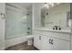 Modern bathroom featuring a shower-tub combo, white marble tiling, and a white vanity at 2511 W Queen Creek Rd # 266, Chandler, AZ 85248