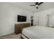 Bedroom featuring neutral tones, a ceiling fan, and a TV over a dresser at 2511 W Queen Creek Rd # 266, Chandler, AZ 85248