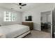 Cozy bedroom featuring neutral tones, a ceiling fan, and a TV above a dresser at 2511 W Queen Creek Rd # 266, Chandler, AZ 85248