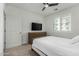 Bright bedroom with a ceiling fan and a TV over a wooden dresser next to the window at 2511 W Queen Creek Rd # 266, Chandler, AZ 85248