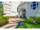 Inviting building entrance with lush landscaping, a waterfall feature, and prominent building signage at 2511 W Queen Creek Rd # 266, Chandler, AZ 85248