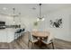 Inviting dining area features a round table, modern lighting, and a view of the kitchen and living room at 2511 W Queen Creek Rd # 266, Chandler, AZ 85248