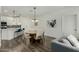 Stylish dining area featuring modern light fixture, kitchen access, and neutral decor at 2511 W Queen Creek Rd # 266, Chandler, AZ 85248