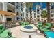 Outdoor fire pit lounge area with comfortable seating, perfect for relaxation and entertaining with palm trees around at 2511 W Queen Creek Rd # 266, Chandler, AZ 85248