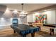 Inviting game room with a pool table, shuffleboard, and cozy fireplace, perfect for socializing and fun at 2511 W Queen Creek Rd # 266, Chandler, AZ 85248