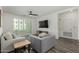 Cozy living room featuring neutral decor, ceiling fan, balcony access, and sleek entertainment center at 2511 W Queen Creek Rd # 266, Chandler, AZ 85248