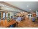 Open lounge and dining area with stylish furniture, a fireplace, and hardwood floors, and tables at 2511 W Queen Creek Rd # 266, Chandler, AZ 85248