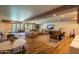 Spacious lounge with modern furniture, a large TV, and access to outdoor spaces, and tables at 2511 W Queen Creek Rd # 266, Chandler, AZ 85248