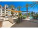 Resort-style outdoor kitchen and dining area with a large grill, bar seating, and shaded lounge areas at 2511 W Queen Creek Rd # 266, Chandler, AZ 85248