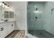 Glass-enclosed shower featuring marble tiling with a black honeycomb tile floor at 2511 W Queen Creek Rd # 266, Chandler, AZ 85248