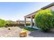 Beautiful backyard featuring covered patio, desert landscaping, and artificial grass at 26168 W Tina Ln, Buckeye, AZ 85396