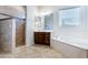 Elegant bathroom showcasing a soaking tub, a walk-in shower, and a stylish vanity with plenty of storage at 26168 W Tina Ln, Buckeye, AZ 85396