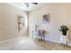 Bright bedroom with a desk, a comfortable chair, and a large window allowing ample natural light at 26168 W Tina Ln, Buckeye, AZ 85396