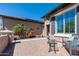 Relaxing outdoor courtyard featuring a water feature, comfortable seating, and stylish tile work at 26168 W Tina Ln, Buckeye, AZ 85396