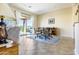 Bright dining area adjacent to the living room featuring a sliding glass door to an outdoor patio at 26168 W Tina Ln, Buckeye, AZ 85396