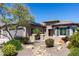 Charming home featuring desert landscaping, solar panels and manicured shrubs, providing curb appeal and eco-friendly features at 26168 W Tina Ln, Buckeye, AZ 85396