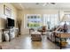 Comfortable living room featuring plush seating, stylish decor, and bright natural light from the large windows at 26168 W Tina Ln, Buckeye, AZ 85396