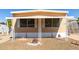 Cozy home with a charming porch featuring decorative white columns and well-maintained gravel landscaping at 2650 W Union Hills Dr # 131, Phoenix, AZ 85027