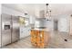 Bright kitchen featuring a rustic island, white cabinets, and stainless steel appliances at 2650 W Union Hills Dr # 131, Phoenix, AZ 85027