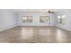 Spacious living room featuring contemporary flooring, ample natural light from large windows, and ceiling fan at 2650 W Union Hills Dr # 131, Phoenix, AZ 85027