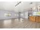 Expansive living space featuring modern floors and an open layout connecting the living and kitchen areas at 2650 W Union Hills Dr # 131, Phoenix, AZ 85027