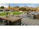 Inviting back yard features artificial turf, fire features, and ample seating with mountain views at 27203 N 78Th Ln, Peoria, AZ 85383