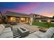 Enjoy an evening in this backyard with a patio, fire pit, outdoor furniture, and string lights at 27203 N 78Th Ln, Peoria, AZ 85383