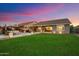 Spacious backyard with a green lawn, comfortable seating area, and inviting string lights at 27203 N 78Th Ln, Peoria, AZ 85383