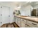 Bright bathroom featuring double sinks, classic cabinets, and a large mirror at 27203 N 78Th Ln, Peoria, AZ 85383